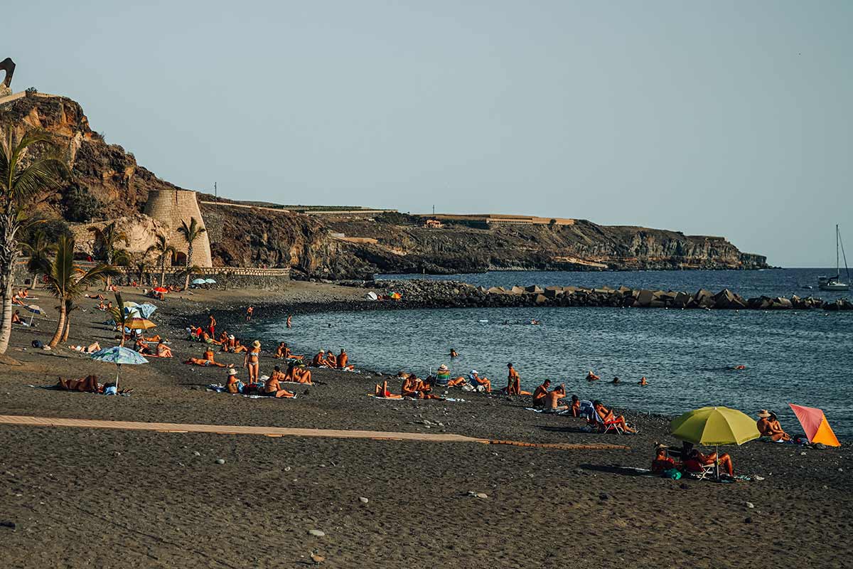 Sunbathing people in the town beach in San Juan, Tenerife
