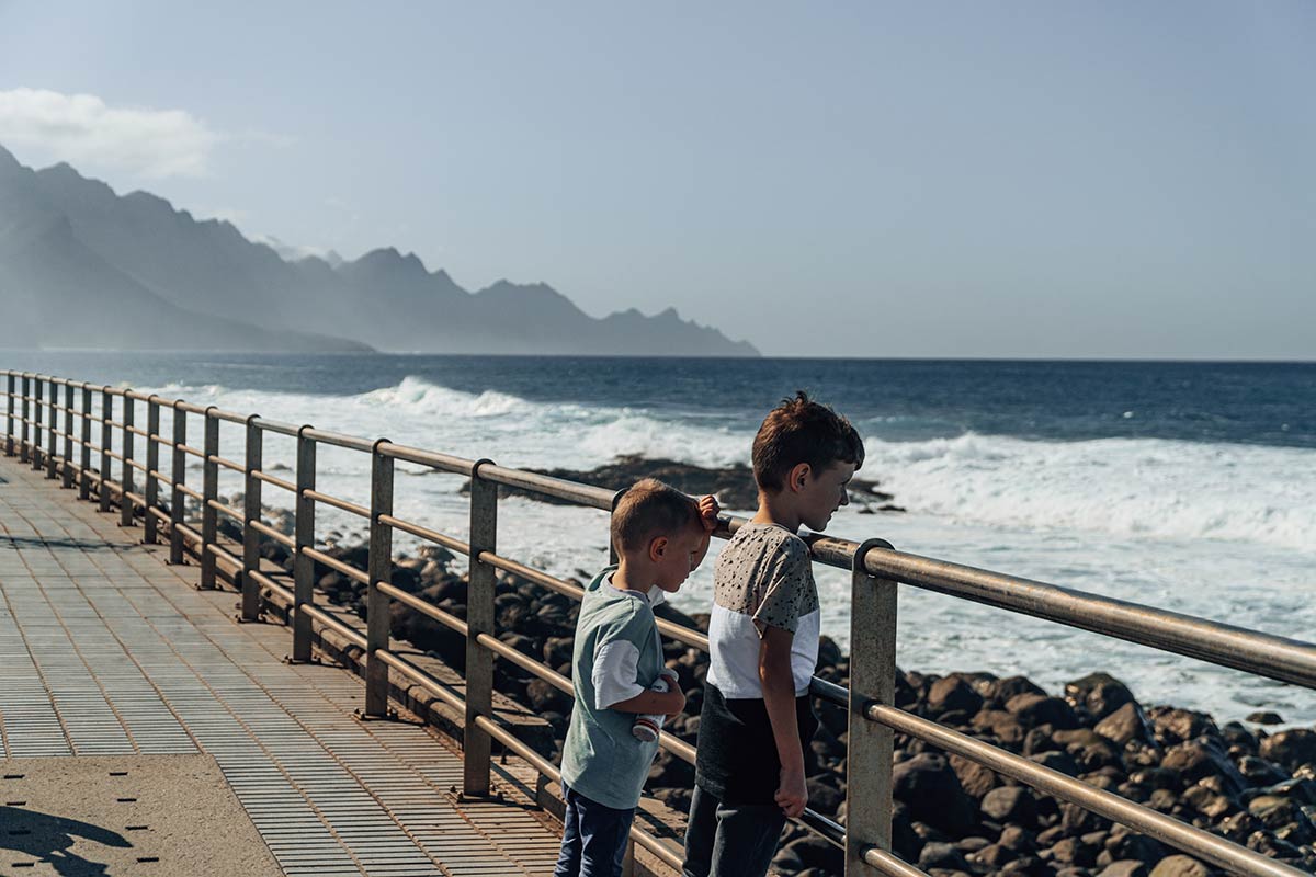 Children watching waves in ocean