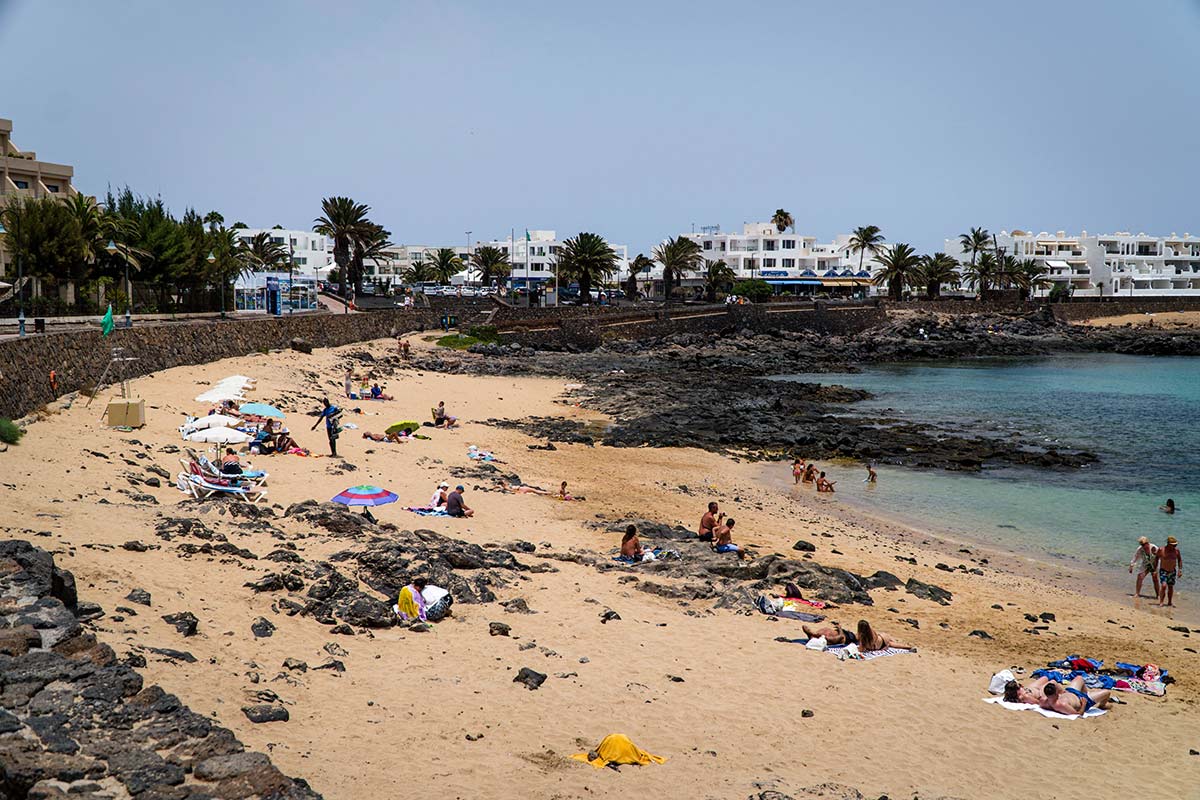 People sunbathing at Playa del Jablillo in Costa Teguise